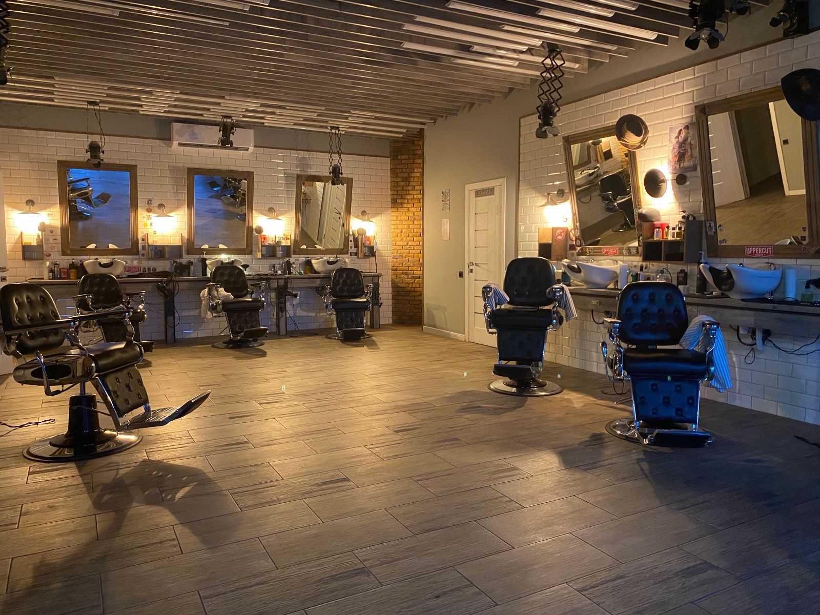Barbershop floor with vintage chairs, mirrors, and warm lighting