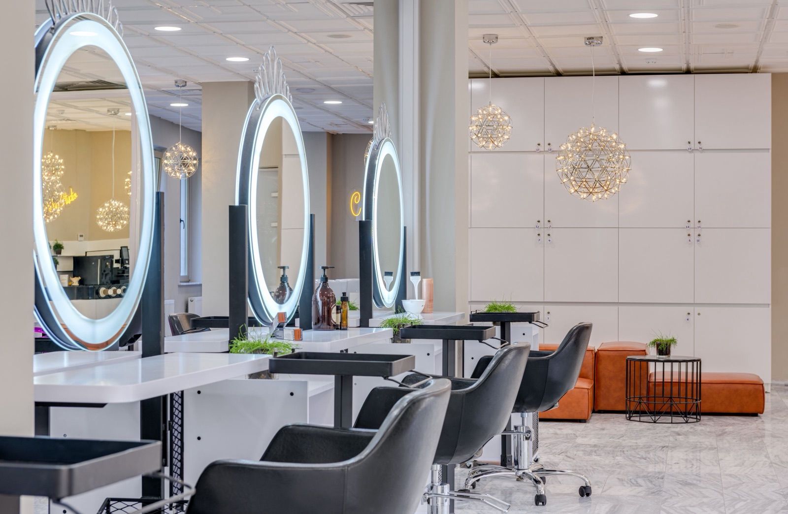 Bright salon floor with ring-lit round mirrors and styling chairs