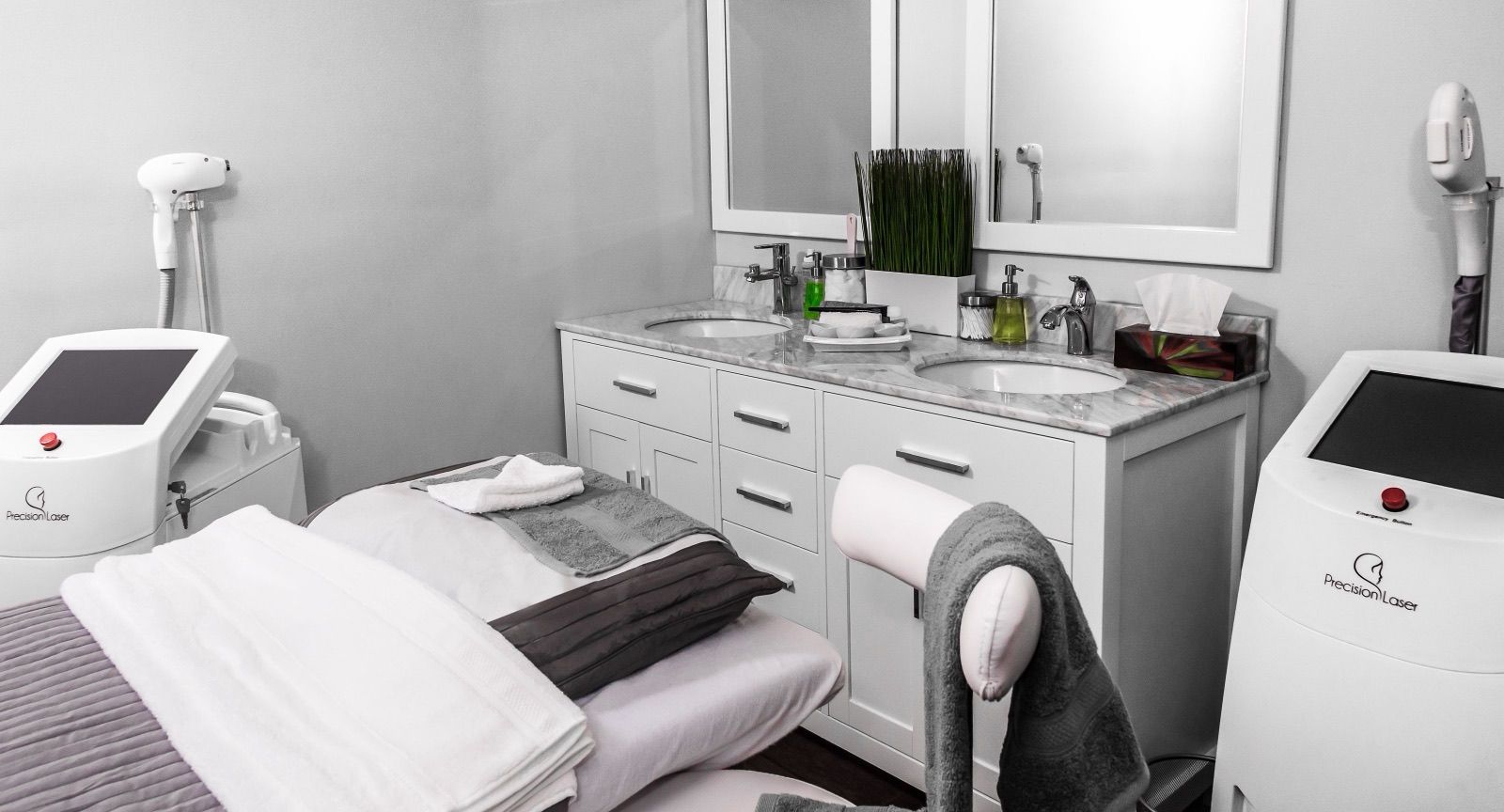 Skin clinic treatment room with a facial bed and aesthetic equipment