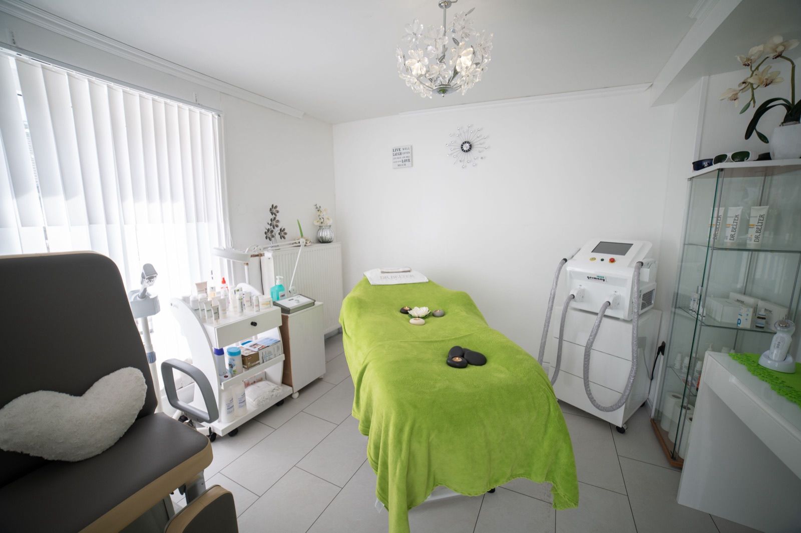Skin clinic treatment room with a facial bed and aesthetic equipment