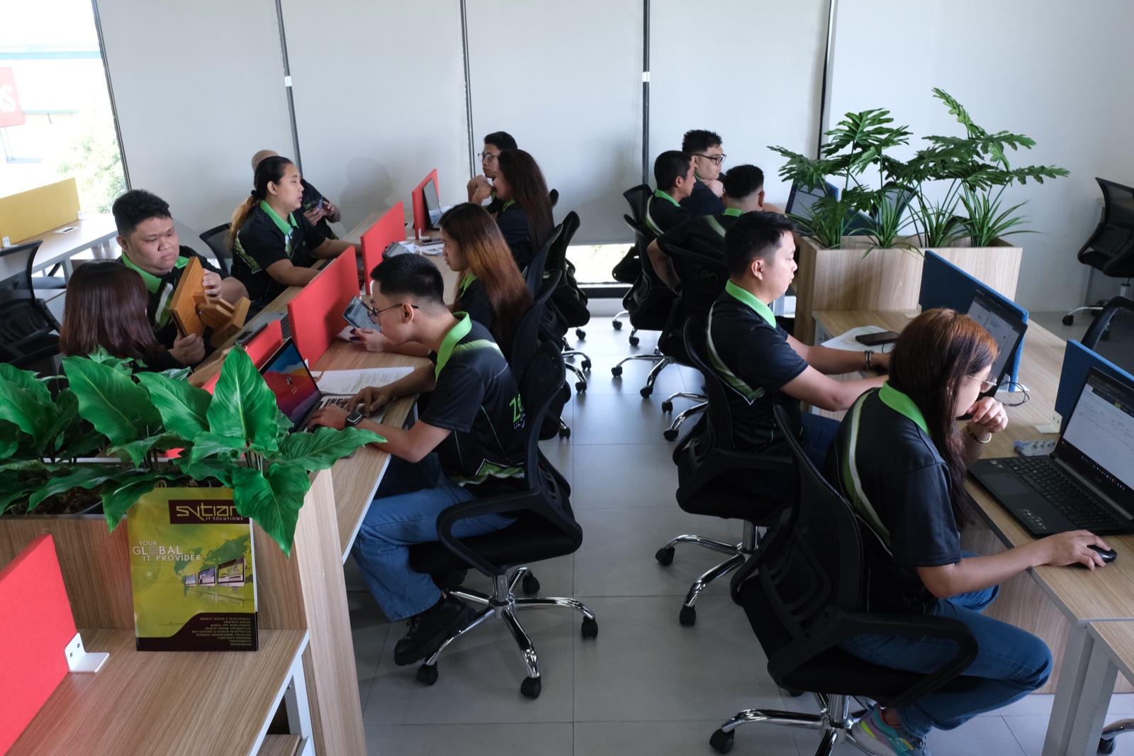 The ZenSoft development floor, staff working at two rows of desks
